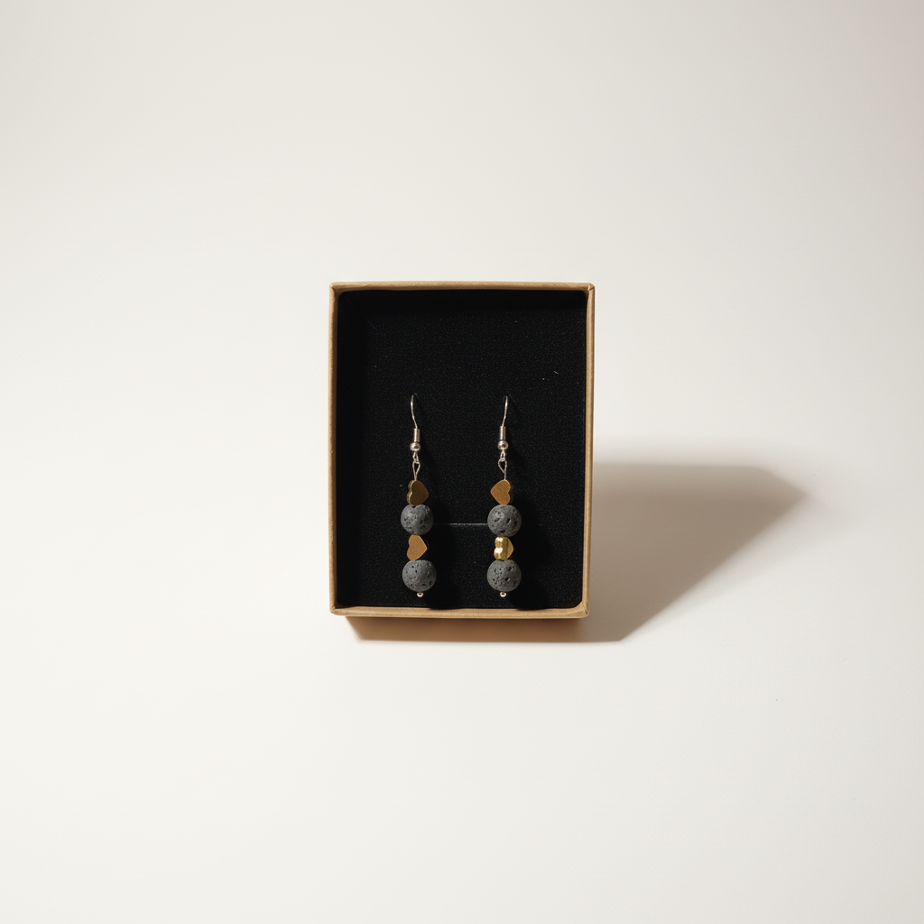 Handmade earrings featuring two gold-plated hearts and two natural Lava stones