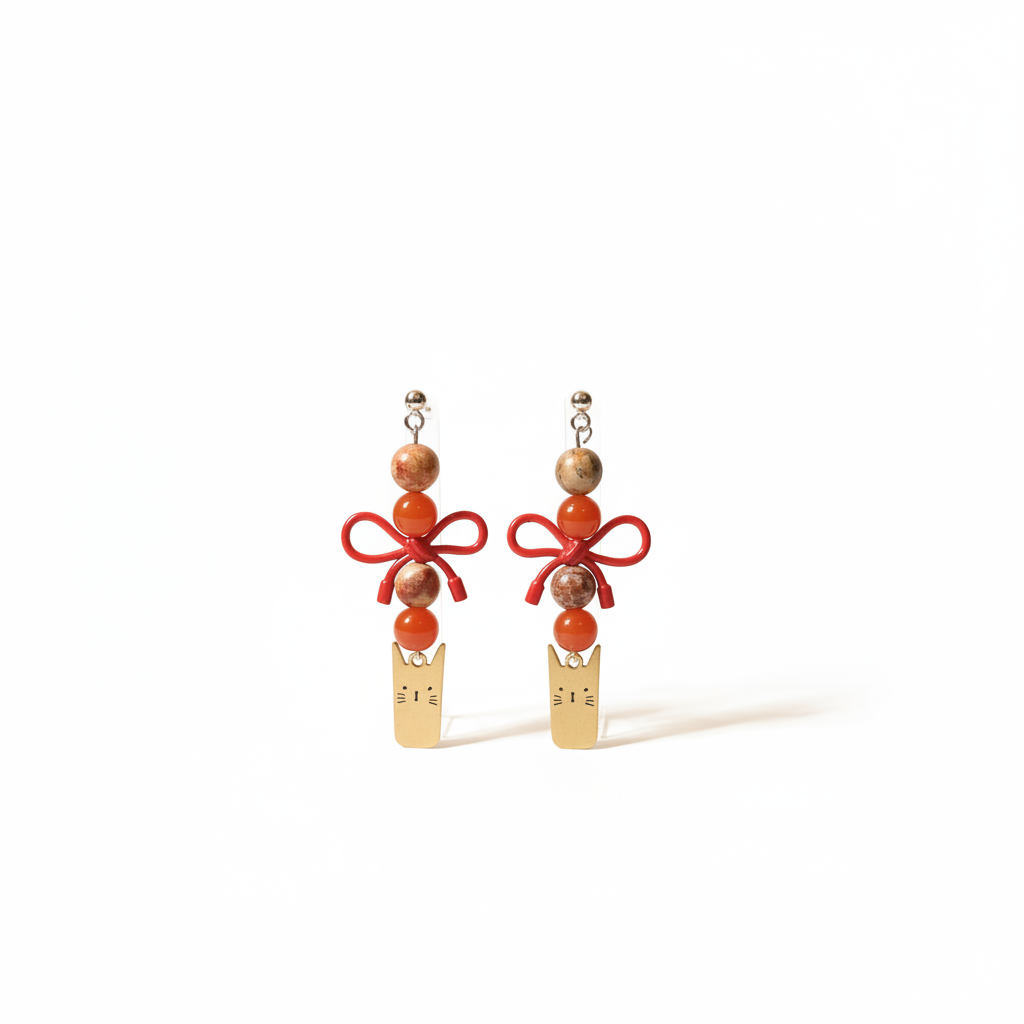 Delicate handmade earrings featuring a charming gold-plated cat, a cute bow, and natural stones – Carnelian and Jasper. 