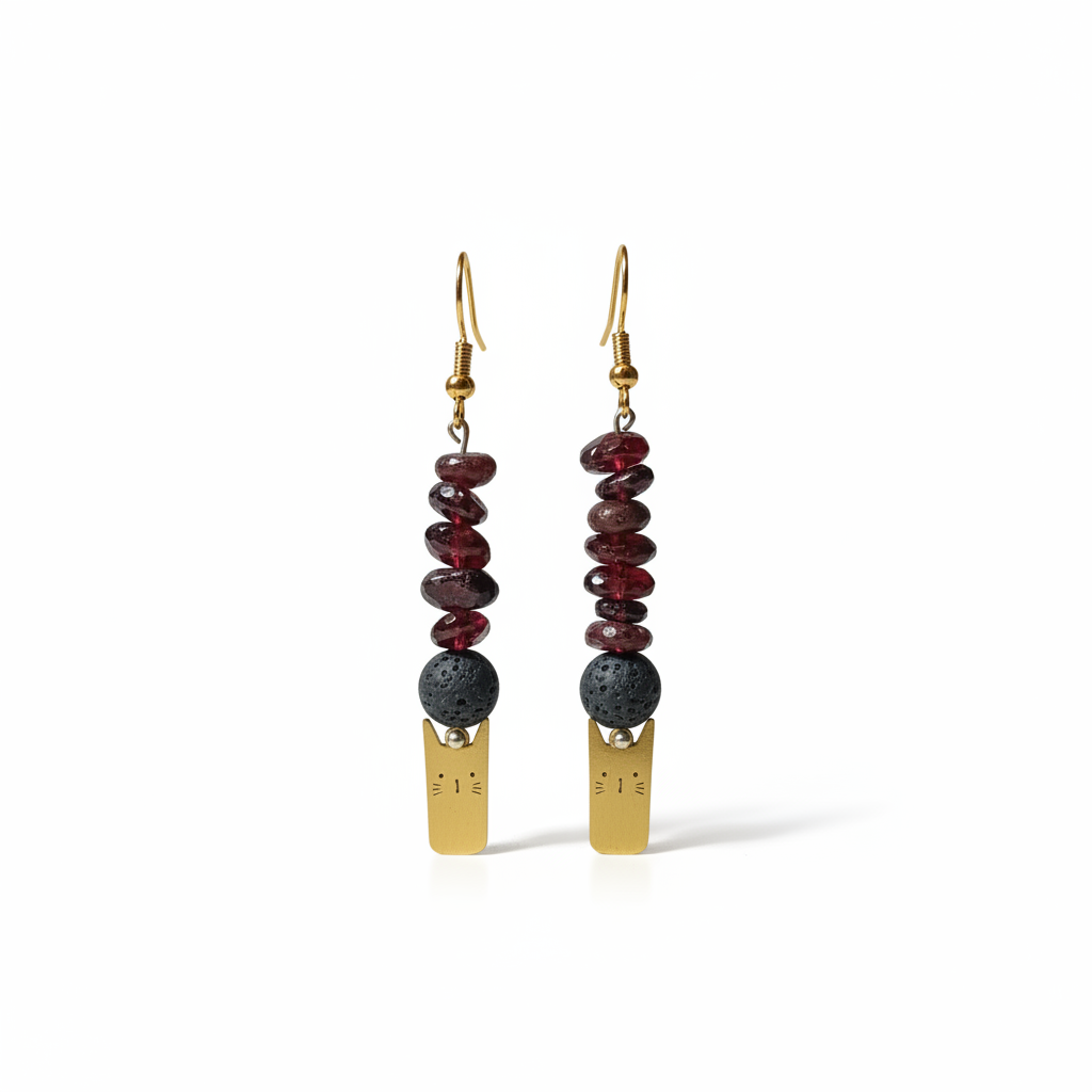 Delicate handmade earrings featuring a charming gold-plated cat adorned with natural Lava stone and Garnet.