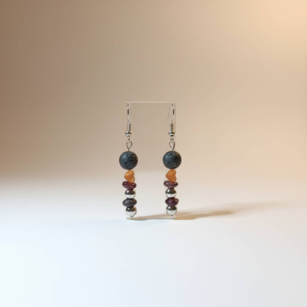 Delicate handmade earrings featuring a gold-plated heart, natural Lava stone, Garnet, and stainless steel beads. 
