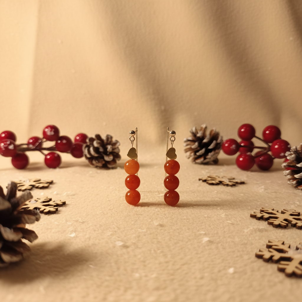 Delicate handmade earrings featuring a gold-plated heart adorned with natural Red Agate.